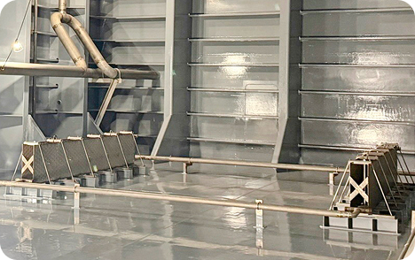 an interior side view of a ship cargo hold containing several OMEGA Laser Plates